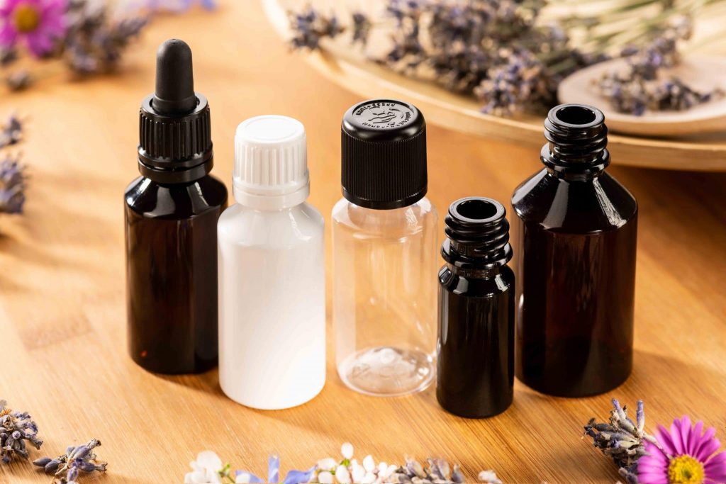 Various dropper bottles on a table in atmospheric shot